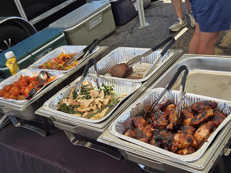 Catering trays of wings, pasta salad and grilled chicken