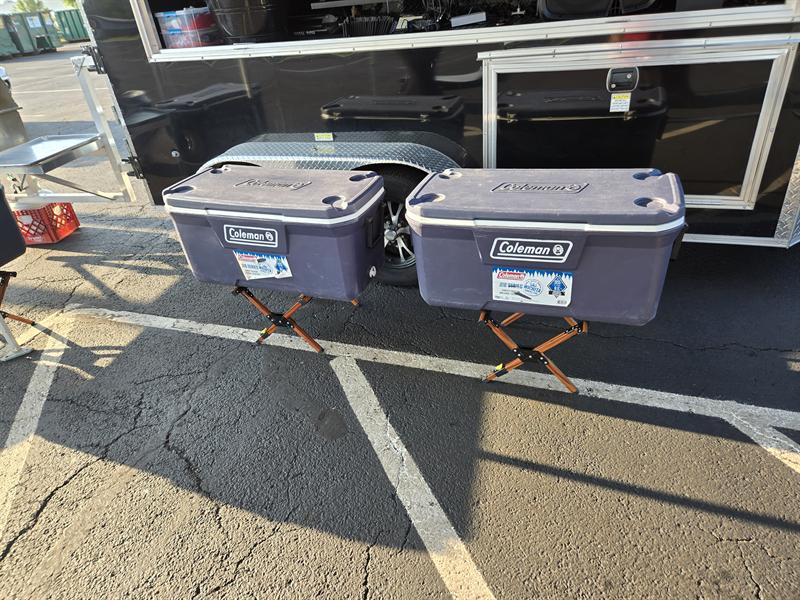 Two coolers on stands beside the trailer